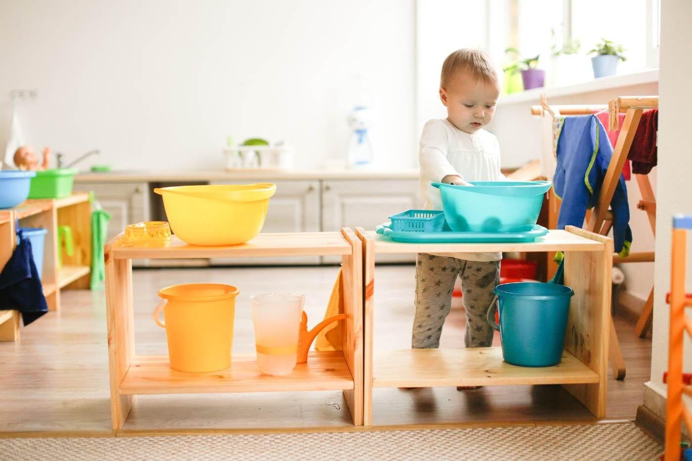 Sensory activities - young toddler playing in sensory bin