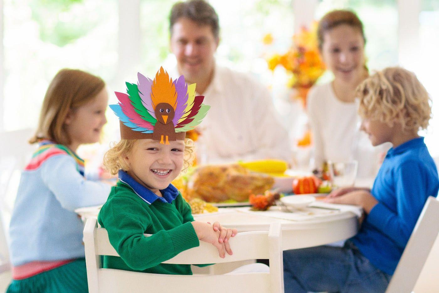 family-eating-thanksgiving-dinner-turkey-hat-kids