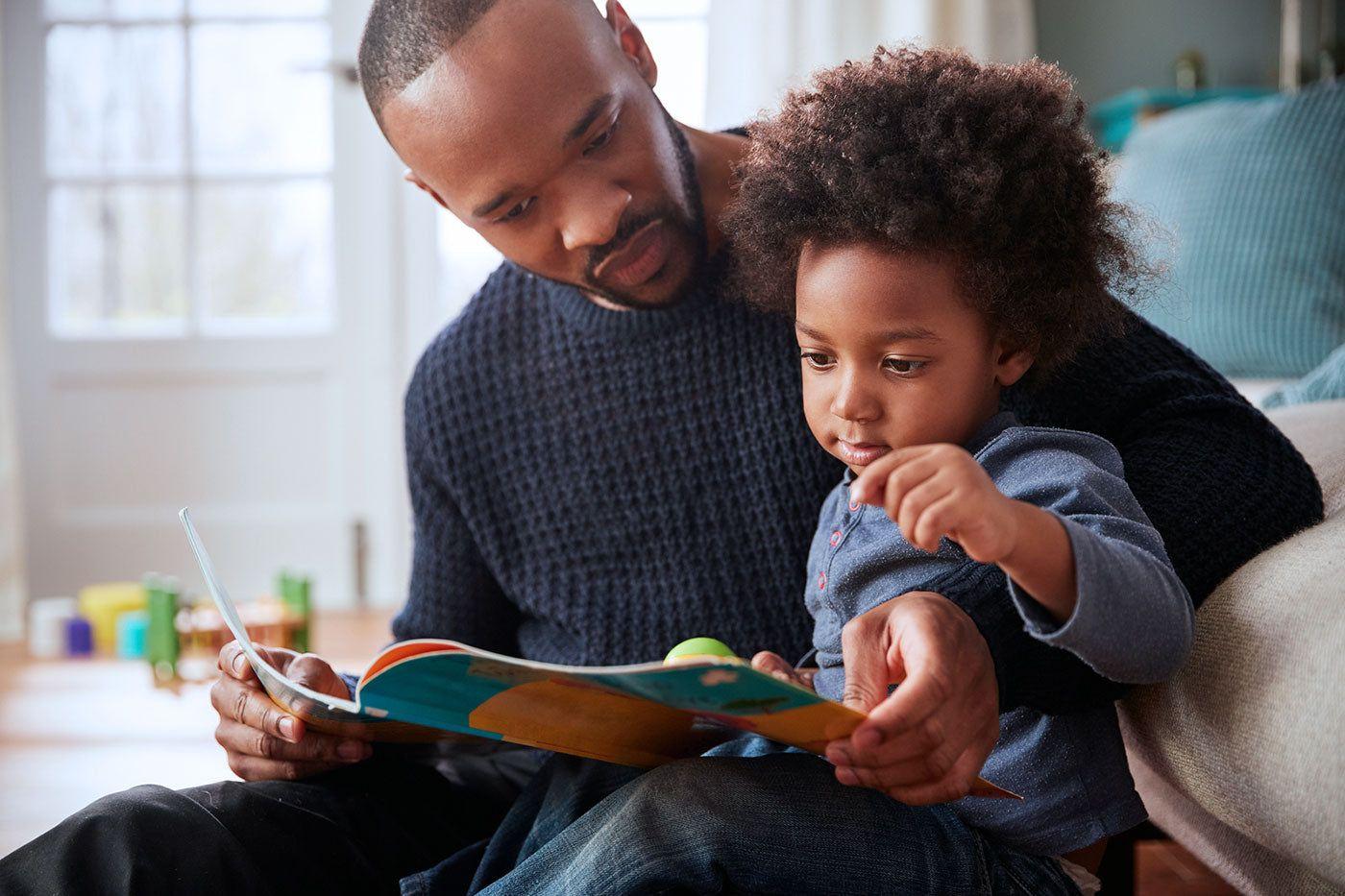 Dad and toddler reading a book