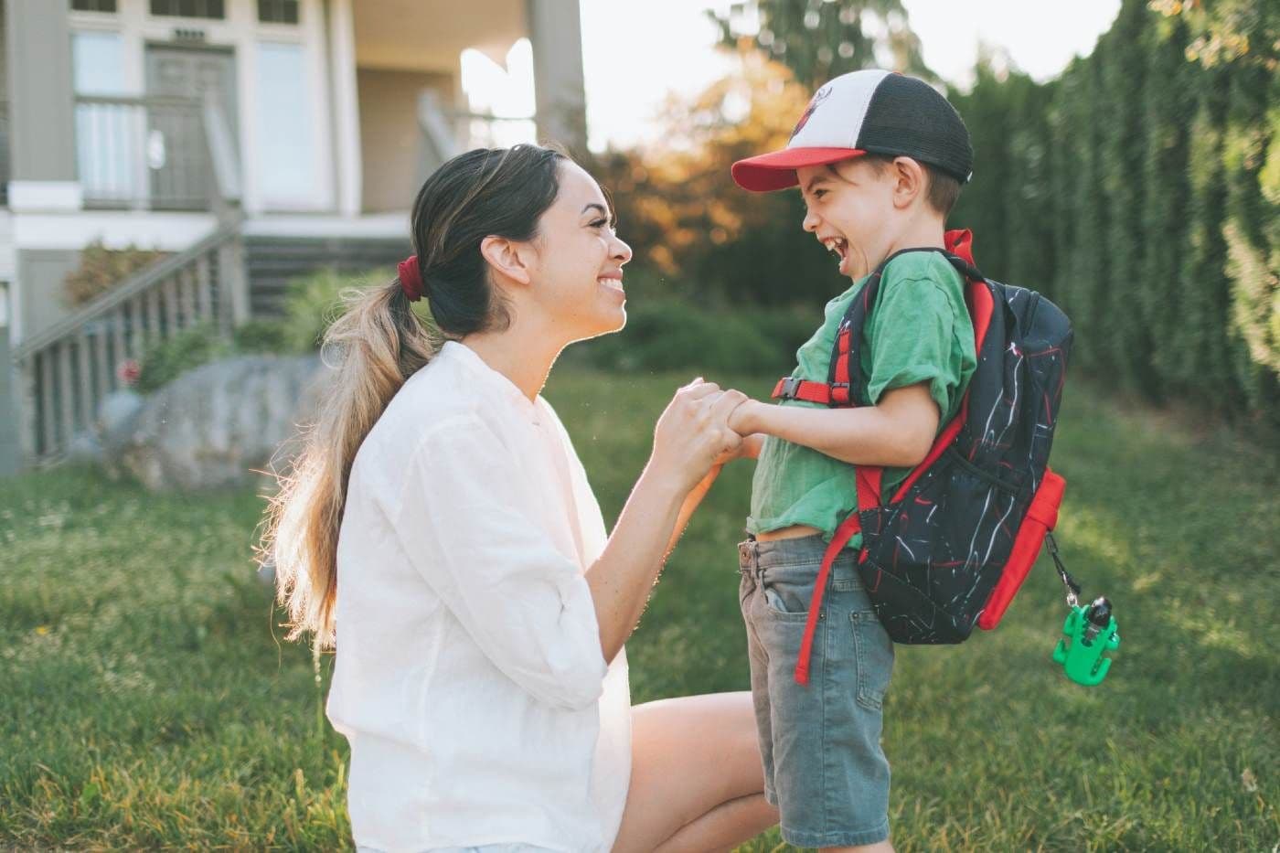 How to prepare for nursery/kindergarten - mother staring lovingly at son who is ready for his first day of school