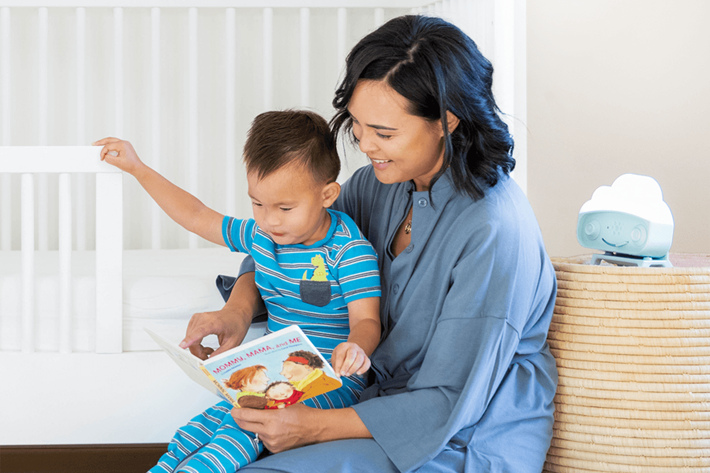A mum and toddler read near SNOObie white noise machine
