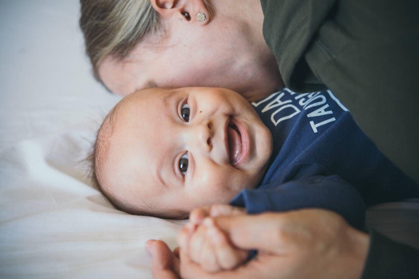 A mum kisses her baby's cheek.