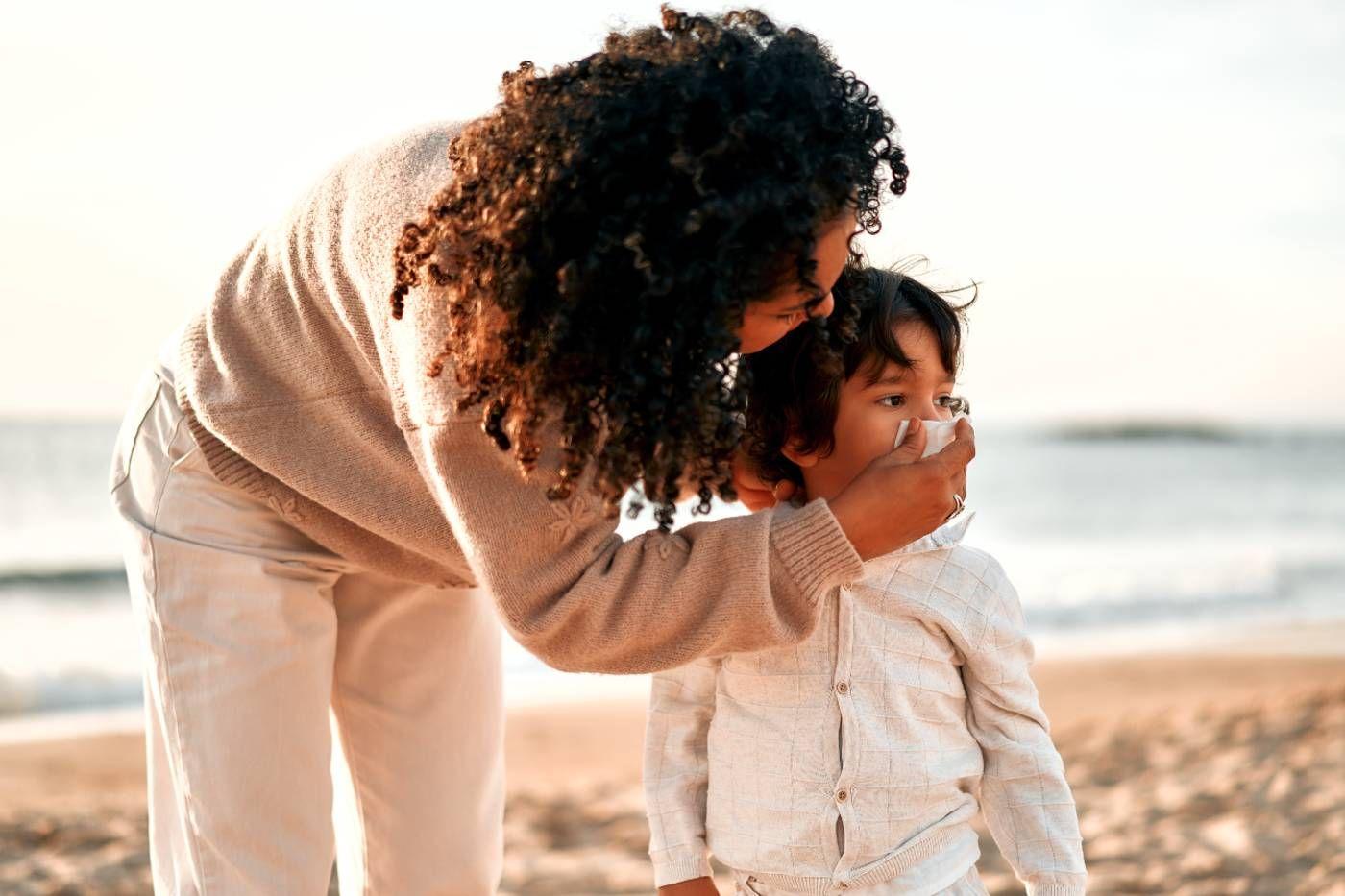 Mucus colour meaning: Mom helping toddler blow nose
