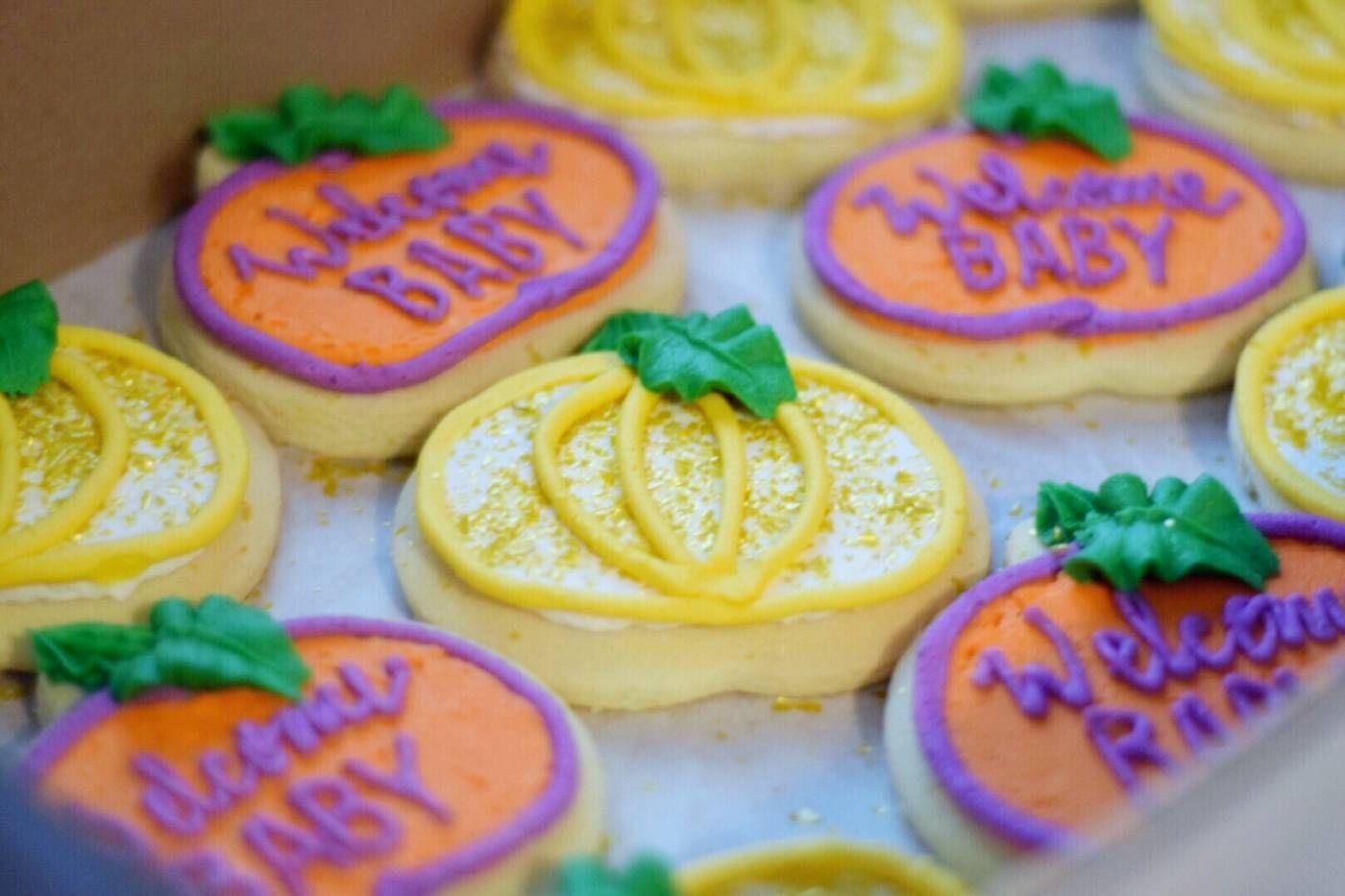 Orange and yellow frosted pumpkin cookies for fall baby shower
