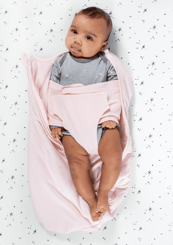 Bands pulled across Baby's arms and chest, snugly securing. Leg flap brought up between Baby's legs, and attached to the arm band